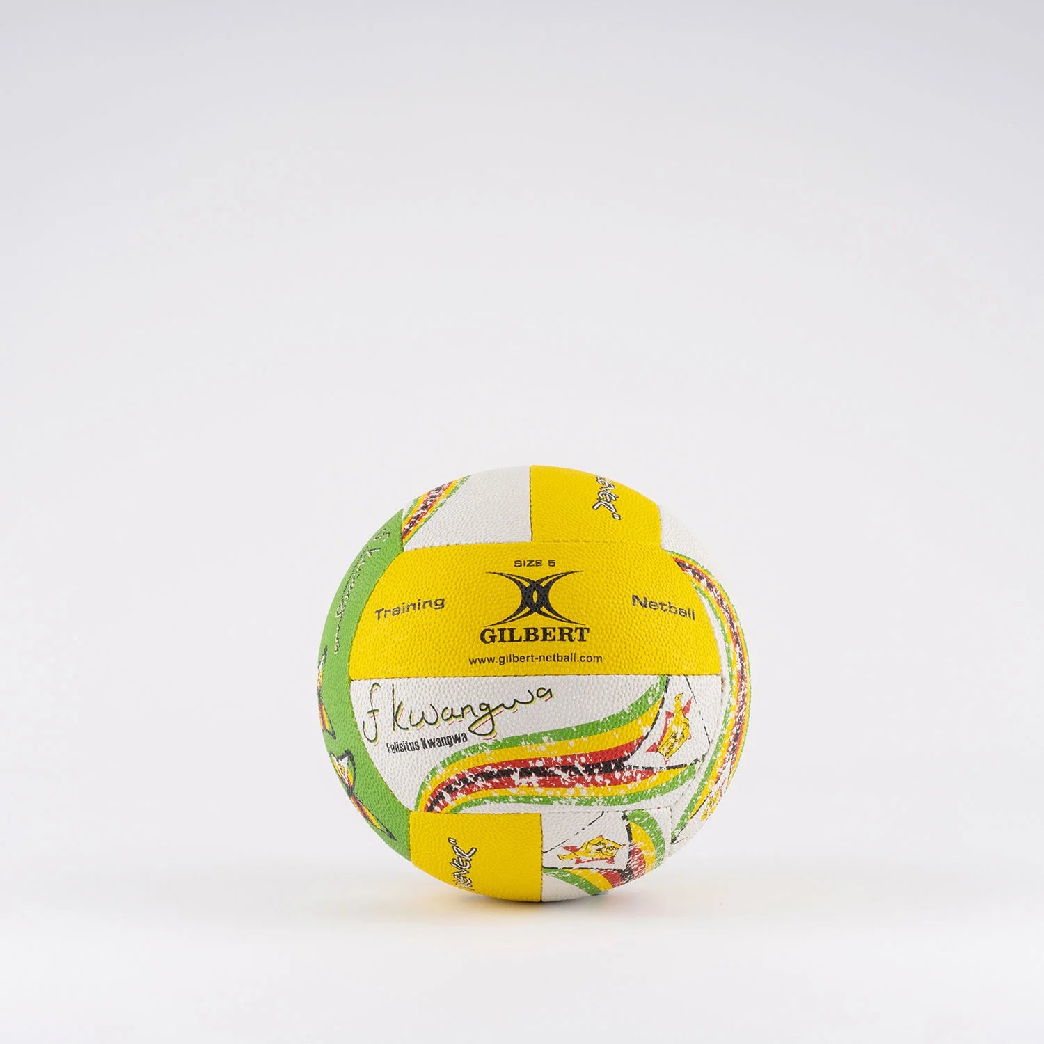 The Gilbert Ambassador Signature Netball (size 5) by Gilbert features yellow, white, and green panels with patterns, small figures, and printed text including "Gilbert," "Training," "Netball," plus a J. Kwangwa signature.
