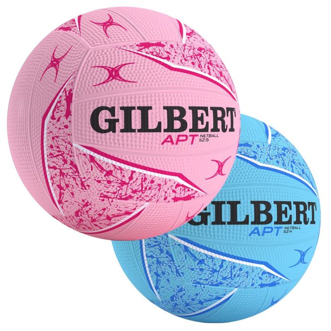 Two Gilbert APT 2026 netballs, one pink and one blue, feature abstract patterns with "GILBERT APT" in bold black letters across the center. With Duragrip for better handling, they’re great for training or outdoor sessions.