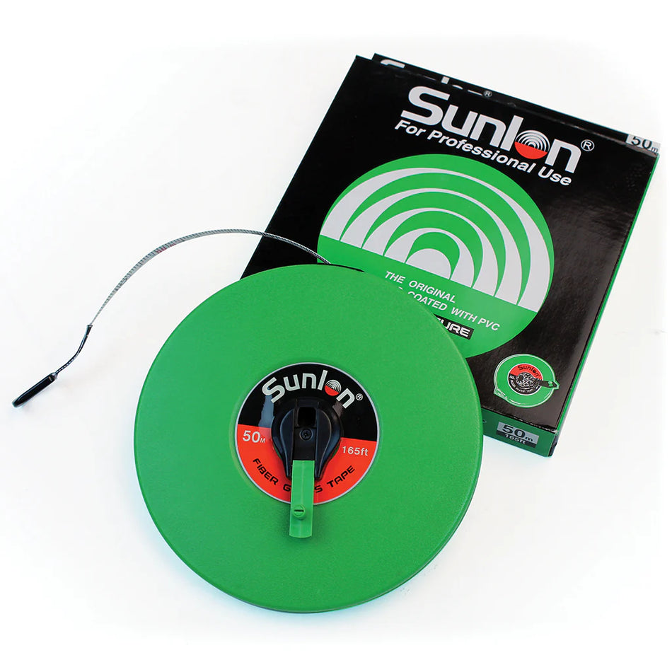 A Martin Berrill Sports Measuring Tape (Closed Case) in green is partially extended next to its black and green packaging. It features a handle, hook end, and durable closed case design for professional use.