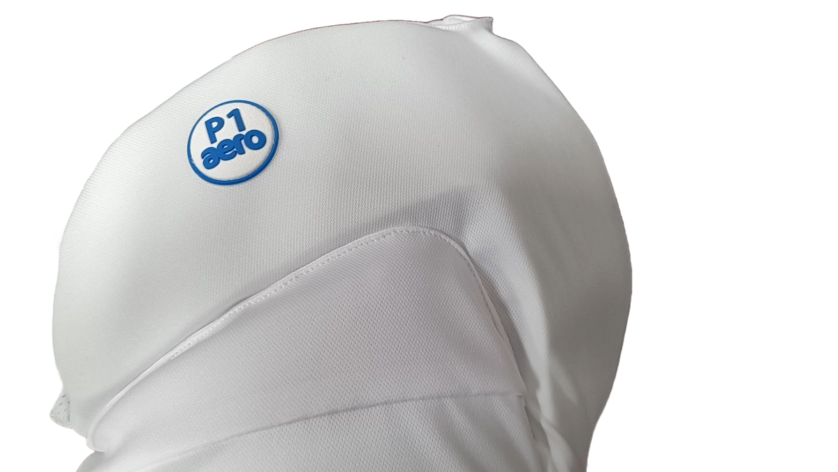 Close-up of the Aero P1 Strippers V8 by Aero, featuring a blue circular aero logo on a white fabric cover, designed for ultimate lower body cricket protection, set against a plain white background.