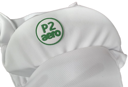 Close-up of Aero P2 Strippers V8 by Aero, a white fabric item featuring a green patch with "P2 aero" in raised letters, designed for ultimate lower body and hip protection in cricket.