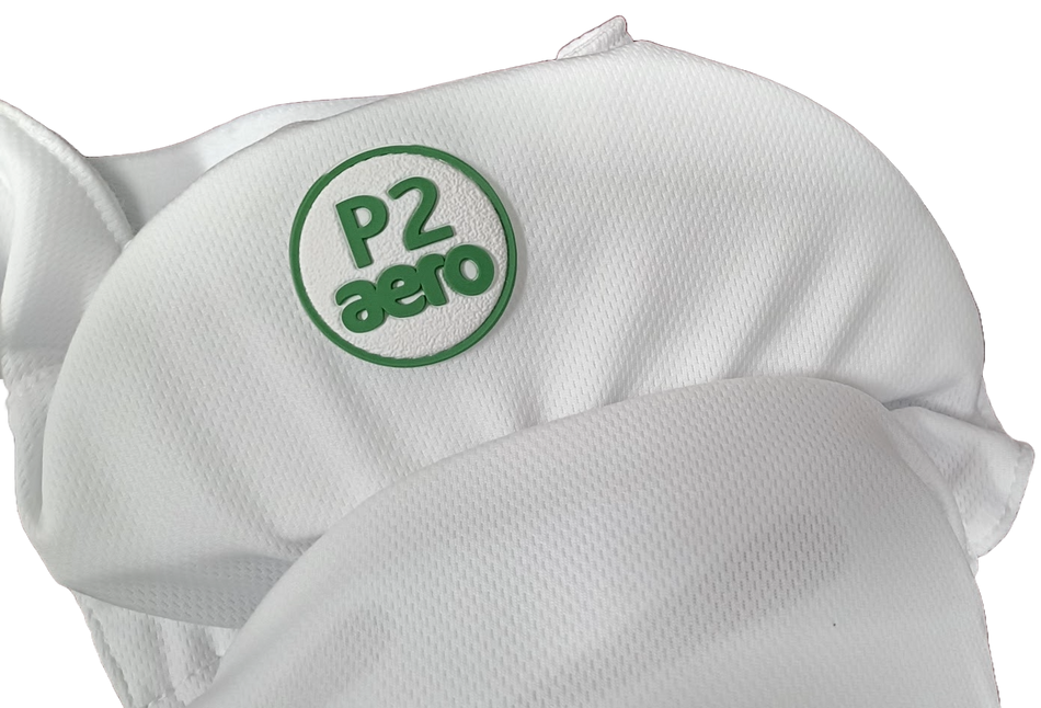 Close-up of Aero P2 Strippers V8 by Aero, a white fabric item featuring a green patch with "P2 aero" in raised letters, designed for ultimate lower body and hip protection in cricket.