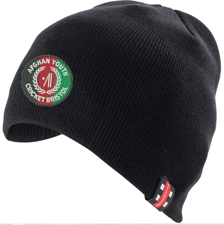 The Gray Nicolls Afghan Youth Cricket Bristol CC Beanie Hat is a black knit hat featuring the club's logo patch in green, white, and red plus a small rectangular label on the brim.
