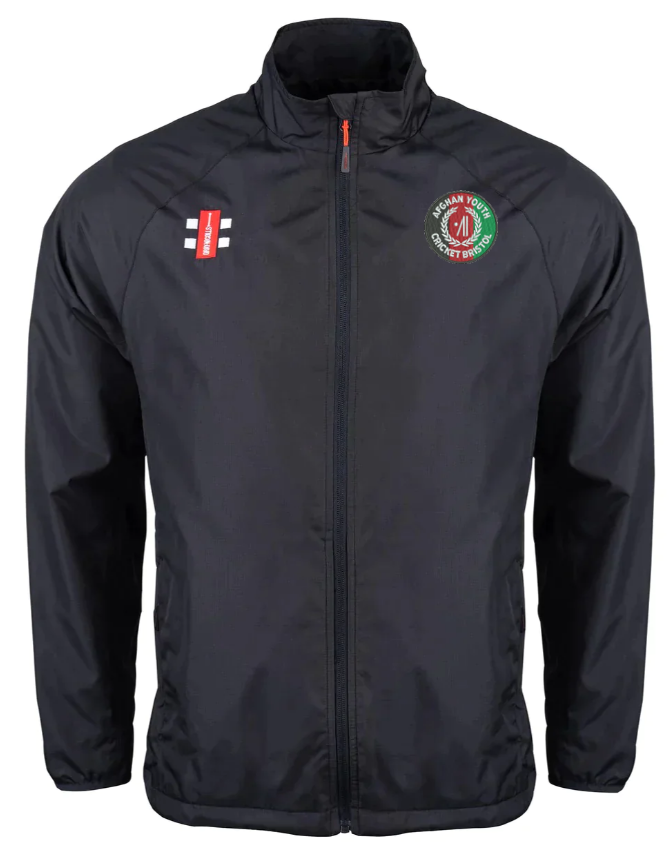 The Gray Nicolls Afghan Youth Cricket Bristol CC Velocity Rain Jacket is a black zip-up jacket with long sleeves, red and white logo on the left chest, green and red emblem on the right chest, stand-up collar, and side pockets.