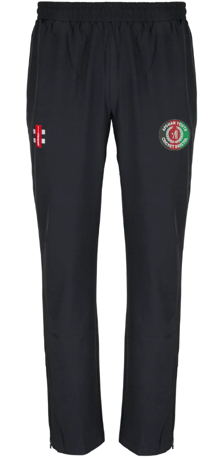 The Gray Nicolls Afghan Youth Cricket Bristol CC Velocity Track Trouser features an elastic waistband, a red and white emblem on the left thigh, and a green-red circular logo with text on the right—ideal for cricket training.