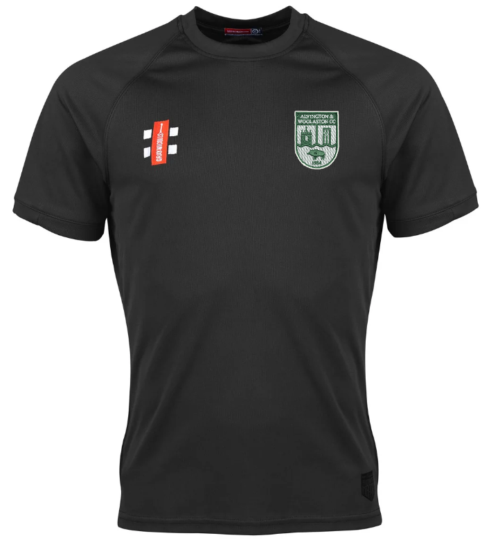 The Alvington & Woolaston Matrix V2 T-Shirt by Gray Nicolls is a black, short-sleeve sports jersey with moisture-wicking fabric, featuring green and white shield and red and white logos on the chest. Displayed on a white background.