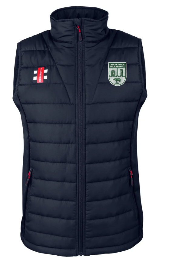 The Gray Nicolls Alvington & Woolaston CC Pro Performance Bodywarmer is navy blue, water repellent, with a front zip, left chest green/white embroidered crest, right red/white cross patch, and zippered side pockets.