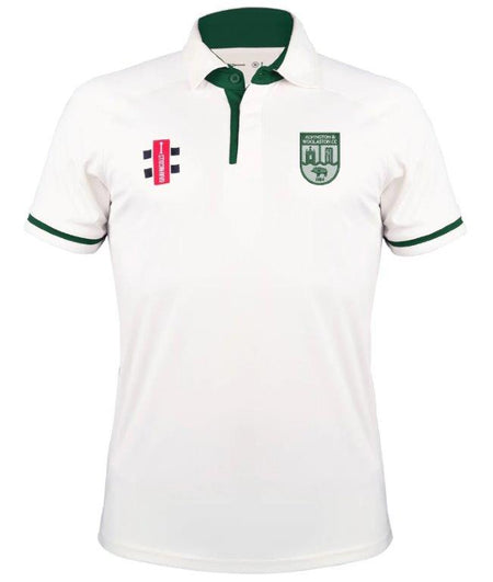 The Gray Nicolls Alvington & Woolaston CC Pro Performance V3 Short Sleeve Shirt is white with dark green trim on the collar and sleeves, featuring a red and black logo, plus a green crest with a building and animal on the chest.