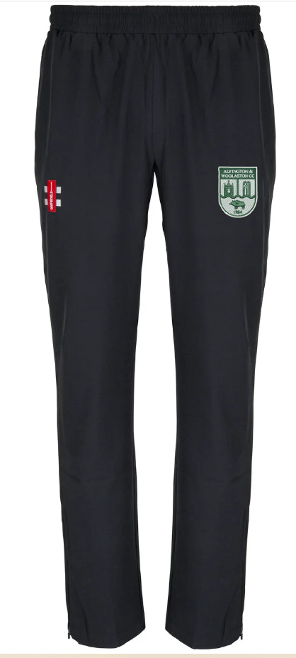 The Gray Nicolls Alvington & Woolaston CC Velocity Track Trouser is a black athletic-fit with an elastic waistband, green and white crest on the right thigh, and a red/white emblem on the left—perfect for cricket training.