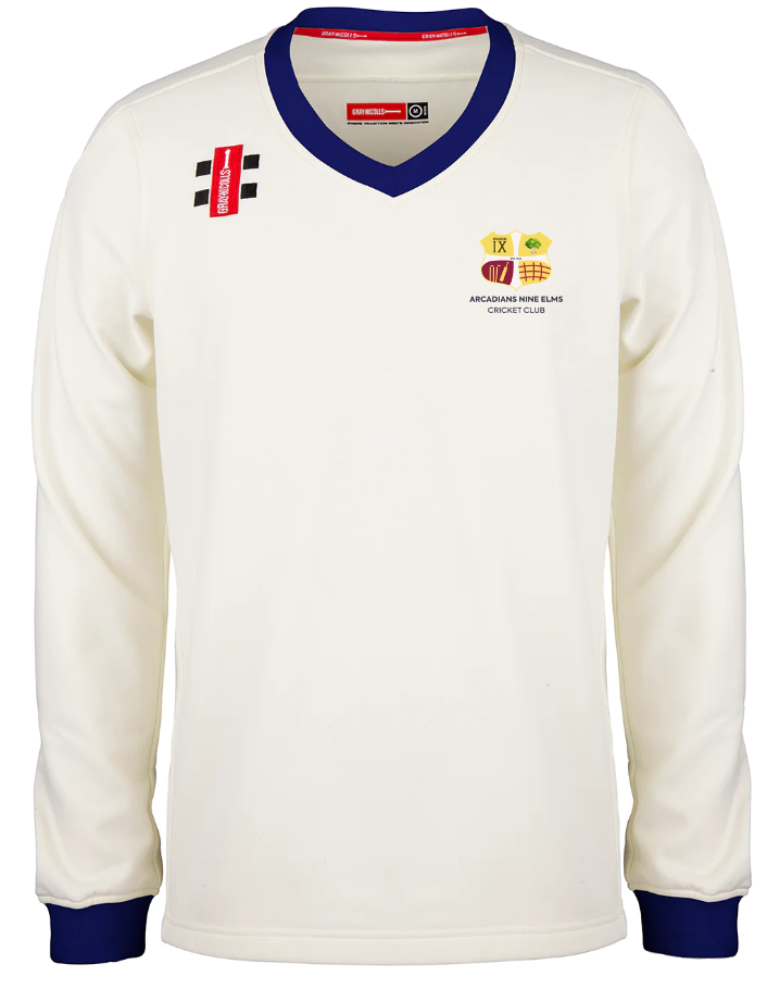 The Gray Nicolls Arcadians Nine Elms CC Pro Performance Sweater is a long-sleeved white cricket sweater with blue trim, featuring the club crest, sponsor logos, and a red label on the chest.