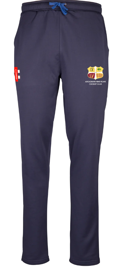The Gray Nicolls Arcadians Nine Elms CC Pro Performance Training Trouser features navy blue fabric, a blue drawstring, red and yellow logos on the right thigh, an extra red logo on the left thigh, and a tailored fit for comfort.