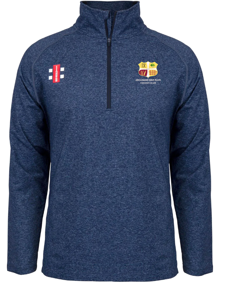 The Gray Nicolls Arcadians Nine Elms CC Velocity Mid Layer is a blue, long-sleeve quarter-zip pullover with a stretch fit, heathered fabric, and features club crest plus sponsor logos on the chest.