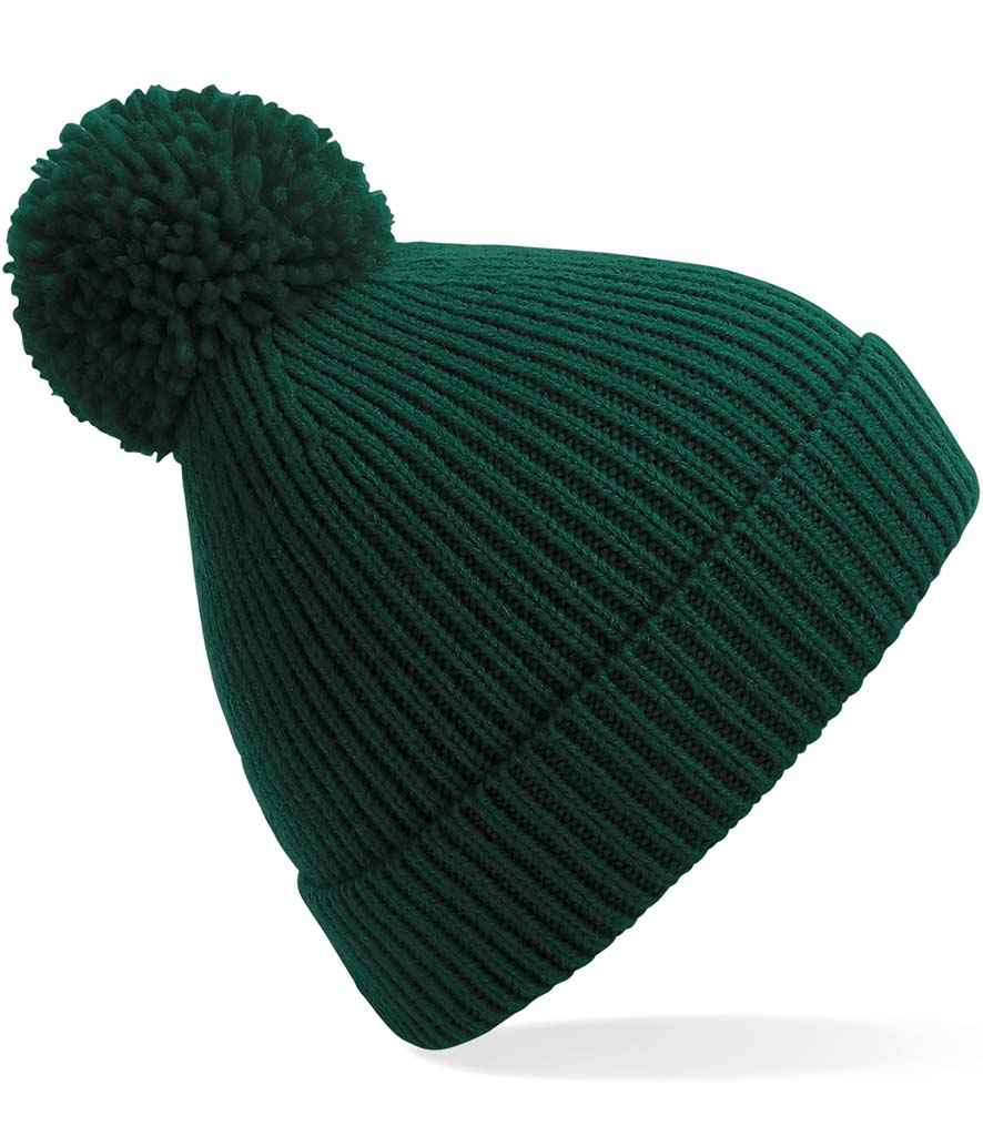 The Kingswood Village CC Knit Ribbed Beanie by Martin Berrill Sports features a dark green color, ribbed knit design, folded brim, and large pom-pom—adding cozy club style to any winter look. Shown on a white background.