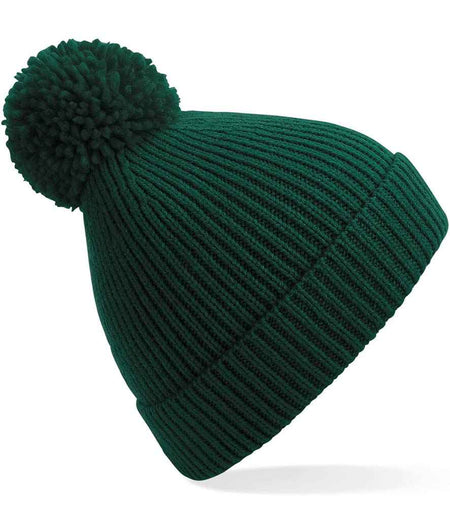 The Kingswood Village CC Knit Ribbed Beanie by Martin Berrill Sports features a dark green color, ribbed knit design, folded brim, and large pom-pom—adding cozy club style to any winter look. Shown on a white background.