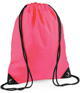 The PenCarrie BagBase Premium Gymsac is a fluorescent pink, water-resistant drawstring bag with black drawstrings and reinforced bottom corners featuring metal grommets.