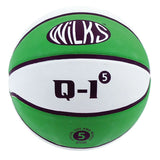 The Wilks Q-1 Basketball features a green and white design with black lines, "WILKS" on the upper panel, and "Q-1⁵", the number 5, plus "Official Size and Weight" on the lower panels. Durable for both indoor and outdoor use.