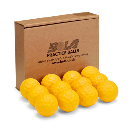 A cardboard box labeled Bola sits behind twelve yellow Bola Bowling Machine Balls, perfect for cricket training, neatly arranged in front of it.