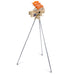 The BOLA Junior Bowling Machine by Bola, in beige, is positioned on a tall silver tripod with four orange tennis balls loaded on top, making it perfect for junior cricket practice. The automatic machine stands out elegantly against a white background.