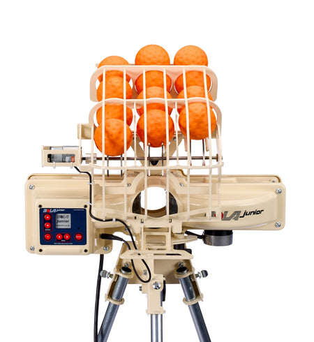 A Bola BOLA Junior Bowling Machine in beige, featuring a wire cage loaded with orange balls, a digital control panel on the left side, and mounted on a tripod—ideal for junior cricket practice—shown against a white background.