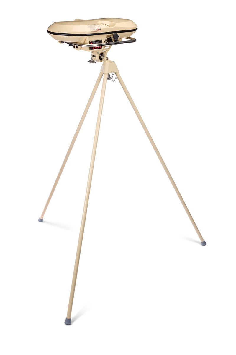 A tan-colored Bola Professional Bowling Machine by Bola, similar in function to an automatic baseball pitching machine, is mounted on a tall three-legged tripod and designed for cricket batting practice.