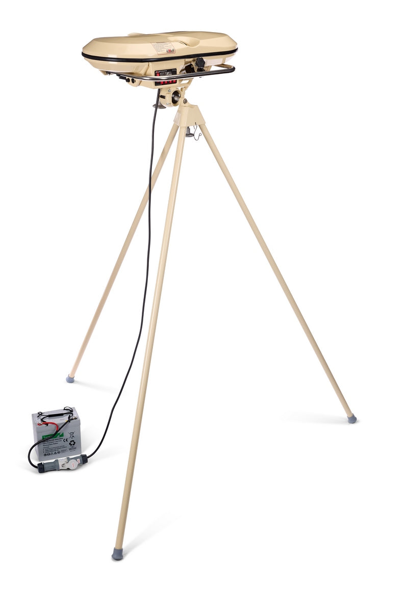 A tan clay pigeon thrower, featuring a tall tripod stand and a build reminiscent of the robust Bola Professional Bowling Machine by Bola, is connected via cable to a battery box on the floor, all set against a white background.