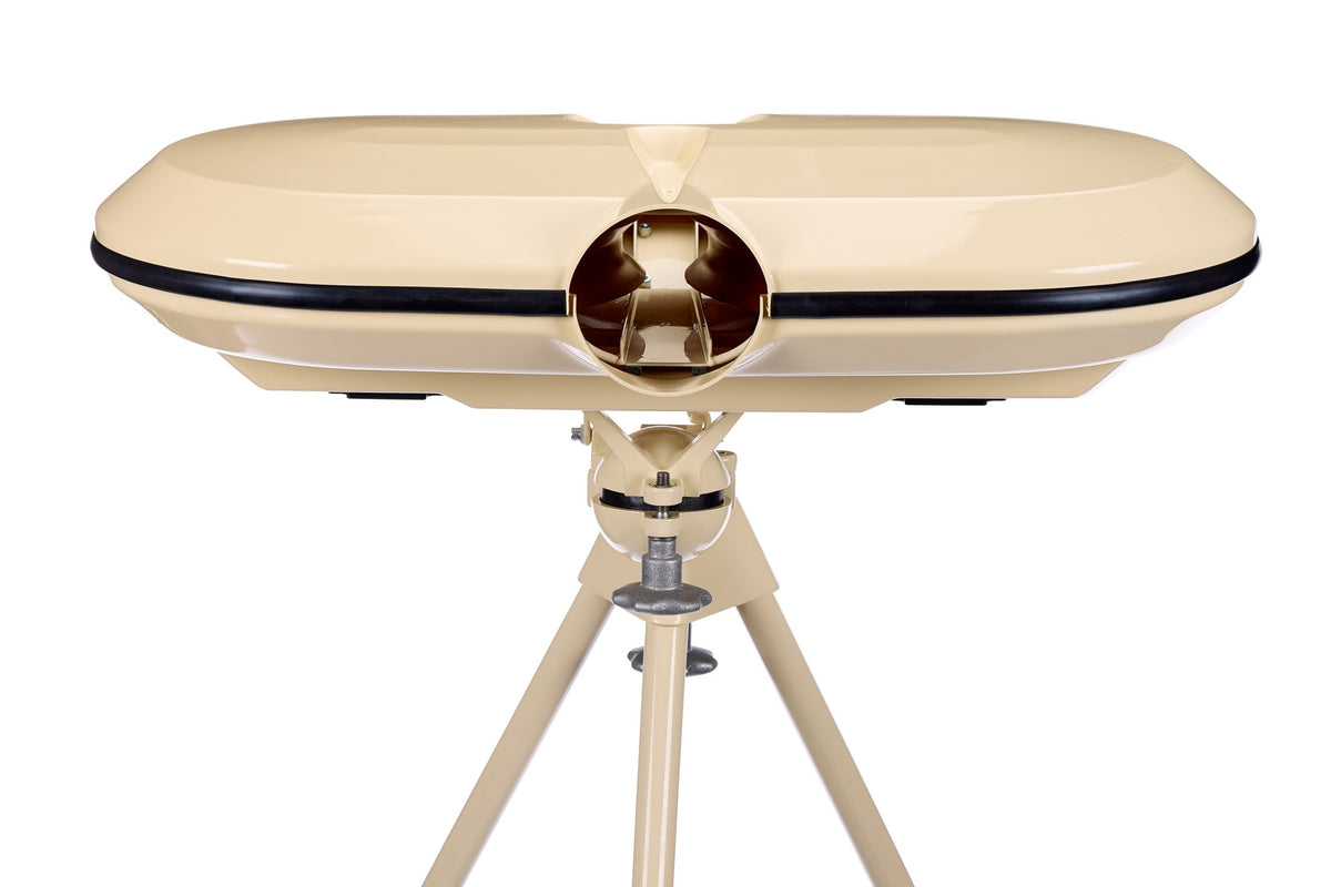 A beige Bola dual-lens device, set on a coordinating tripod against a white background, resembles vintage binoculars or a viewfinder and is designed for use with the Bola Professional Bowling Machine during cricket batting practice.