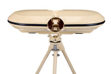 A beige Bola dual-lens device, set on a coordinating tripod against a white background, resembles vintage binoculars or a viewfinder and is designed for use with the Bola Professional Bowling Machine during cricket batting practice.