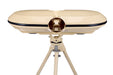 A beige Bola dual-lens device, set on a coordinating tripod against a white background, resembles vintage binoculars or a viewfinder and is designed for use with the Bola Professional Bowling Machine during cricket batting practice.