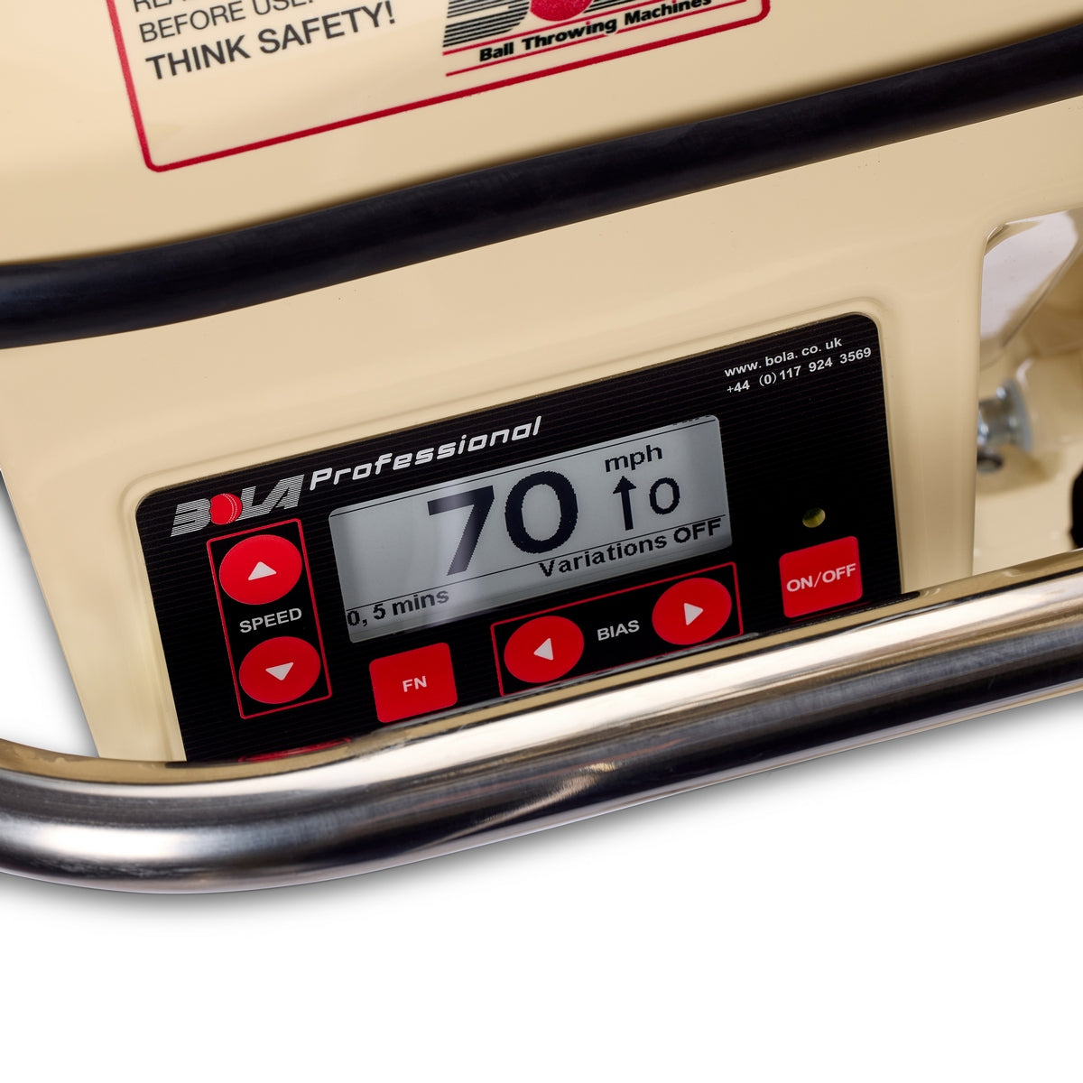 Here is a revised version of the sentence, incorporating the provided product data: Close-up of the Bola Professional Bowling Machine’s digital control panel by Bola, featuring an ePaper display showing a 70 mph speed for cricket batting practice, with red buttons below and a safety warning label above.