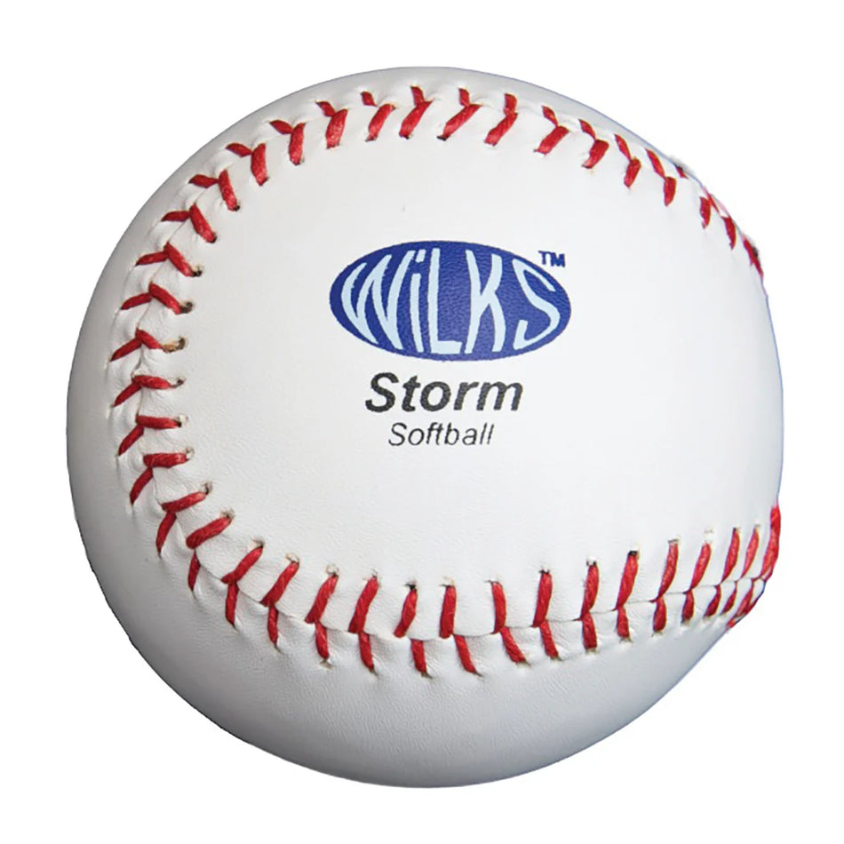 The Wilks Synthetic Softball Storm Ball is a match-quality softball with a cork core, red stitching, and the Wilks Storm Softball logo printed in blue and black on its white surface, displayed against a plain white background.