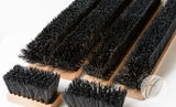 Several Spare Brush Kit - Multi Boot Wiper brushes by Harrod Sport, featuring dense black polypropylene bristles, are laid out in varying sizes on a white surface.