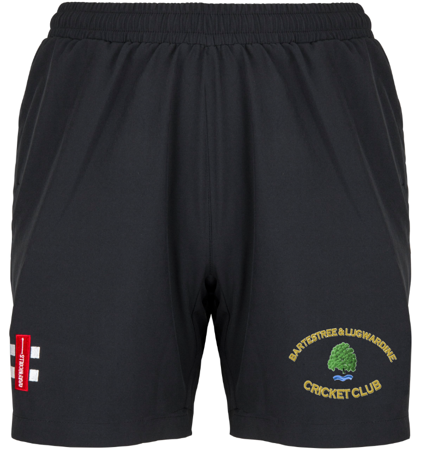 Bartestree & Lugwardine CC Ladies Velocity Shorts by Gray Nicolls feature an elastic waistband, a club logo with green tree on the right leg, and a red England flag patch on the left—ideal shorts for cricket fans.