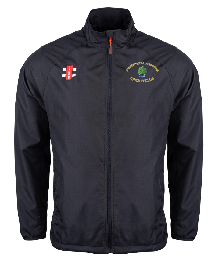 The Gray Nicolls Bartestree & Lugwardine CC Velocity Rain Jacket is a black, lightweight water-repellent zip-up with dual chest logos—red cricket stumps and a green tree for the club. Ideal for practice or matches.
