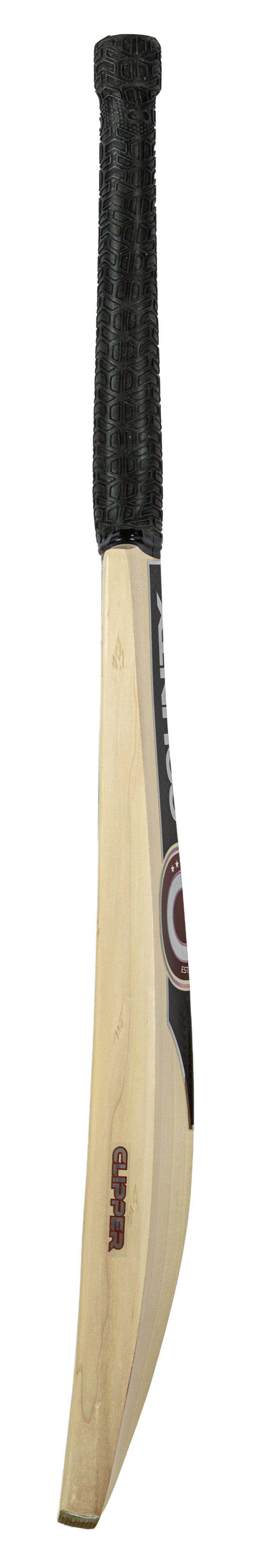 A Hunts County Clipper Limited Edition Junior Cricket Bat, featuring a black textured grip and a flat blade, stands upright against a white background—an ideal premium choice for young cricketers seeking quality from Hunts County.