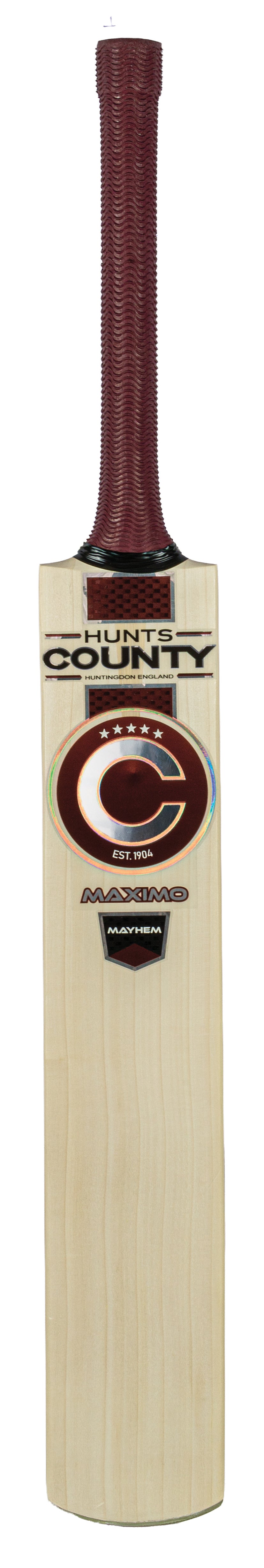 The Hunts County Maximo Mayhem Junior Cricket Bat is expertly crafted from premium English willow and features a maroon handle, distinctive Hunts County logos, text, and a circular Maximo Mayhem sticker on the blade—making it an excellent choice for young cricketers.