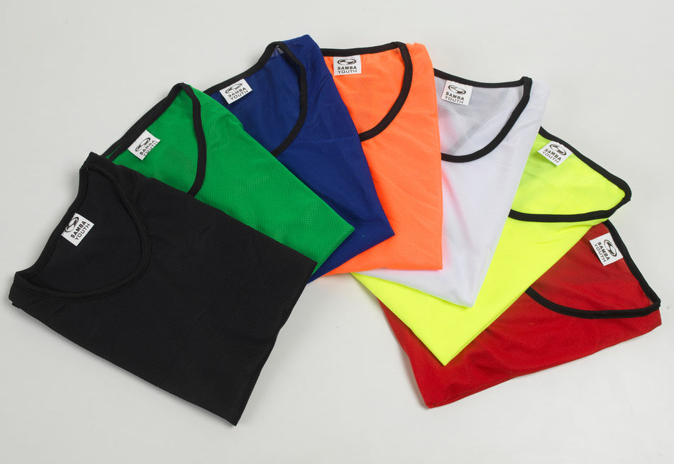 Seven Samba Mesh Training Bibs by Samba Sports in black, green, blue, orange, white, yellow, and red are fanned out on a white surface. Each bib has a black collar and a visible label at the neckline.