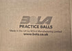 White cardboard box with black text reads: Bola Senior Bowling Machine Practice Balls (White) - Dozen. Ideal for cricket training and bowling machines. Made in the UK by Bola. "BOLA" features a cricket ball design. www.bola.co.uk.