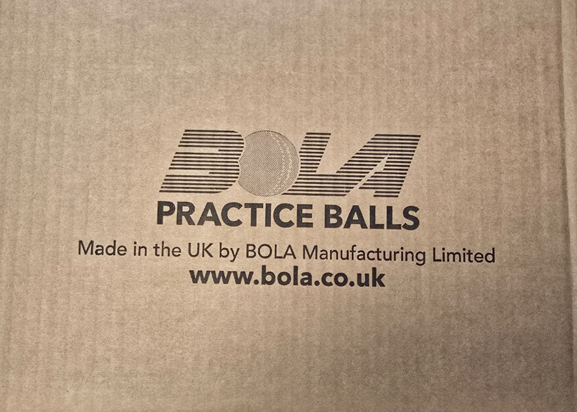 White cardboard box with black text reads: Bola Senior Bowling Machine Practice Balls (White) - Dozen. Ideal for cricket training and bowling machines. Made in the UK by Bola. "BOLA" features a cricket ball design. www.bola.co.uk.