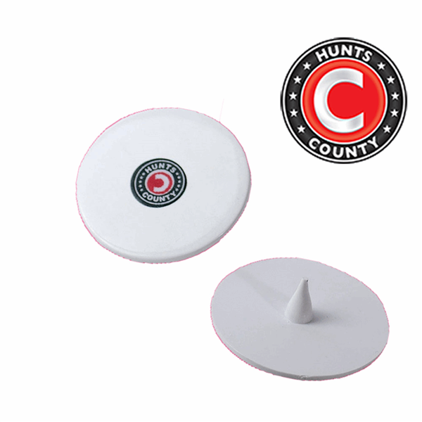 A pair of Hunts County Bowlers Markers is shown in white plastic, one displaying the Hunts County logo on top and the other flipped to reveal a pointed spike underneath. The Hunts County logo appears in the top right corner, highlighting these markers as effective cricket training aids for bowlers to improve their consistency.