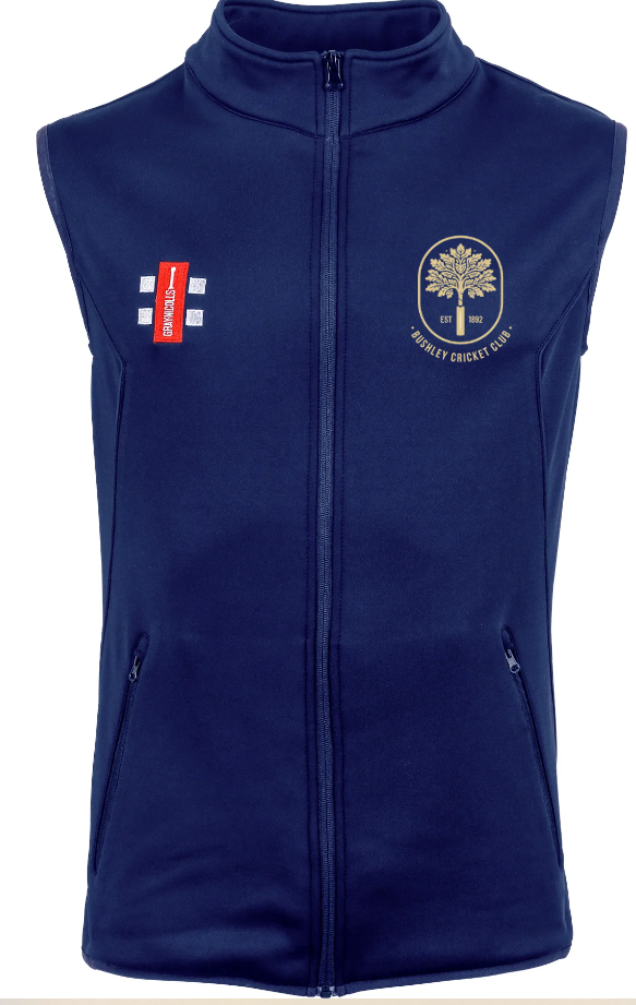 The Gray Nicolls Bushley CC Storm Thermo Bodywarmer is a navy blue sleeveless zip-up vest with zip pockets, a gold club crest and text on the left chest, plus a red and white logo with two white stripes on the right chest.