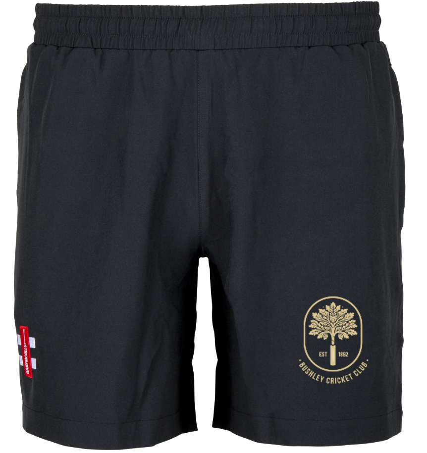 Bushley CC Velocity Shorts by Gray Nicolls: black athletic cricket shorts with an elastic waistband, a gold tree-emblem and Bosley Cricket Club text on the right leg, plus a small red-and-white patch on the left. Perfect for training or matches.