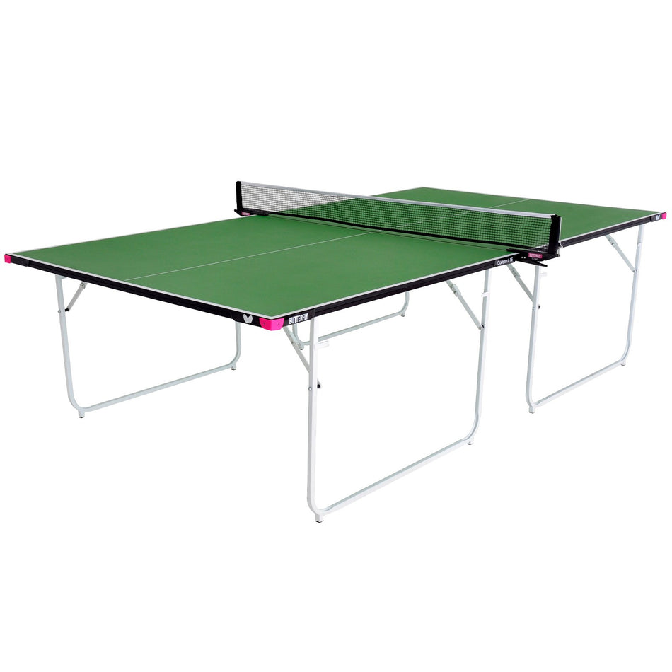 The Butterfly Compact 16 Wheelaway Table Tennis Table by Butterfly features a green playing surface with a net in the center, foldable metal legs, a black-edged design, and stylish pink corner accents—making it an ideal and fashionable choice for any home table tennis setup.