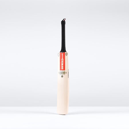 The Gray Nicolls Legend Gold Edition SH Cricket Bat, crafted from English willow with a black handle and red GRAY-NICOLLS label, stands upright against a plain white background.