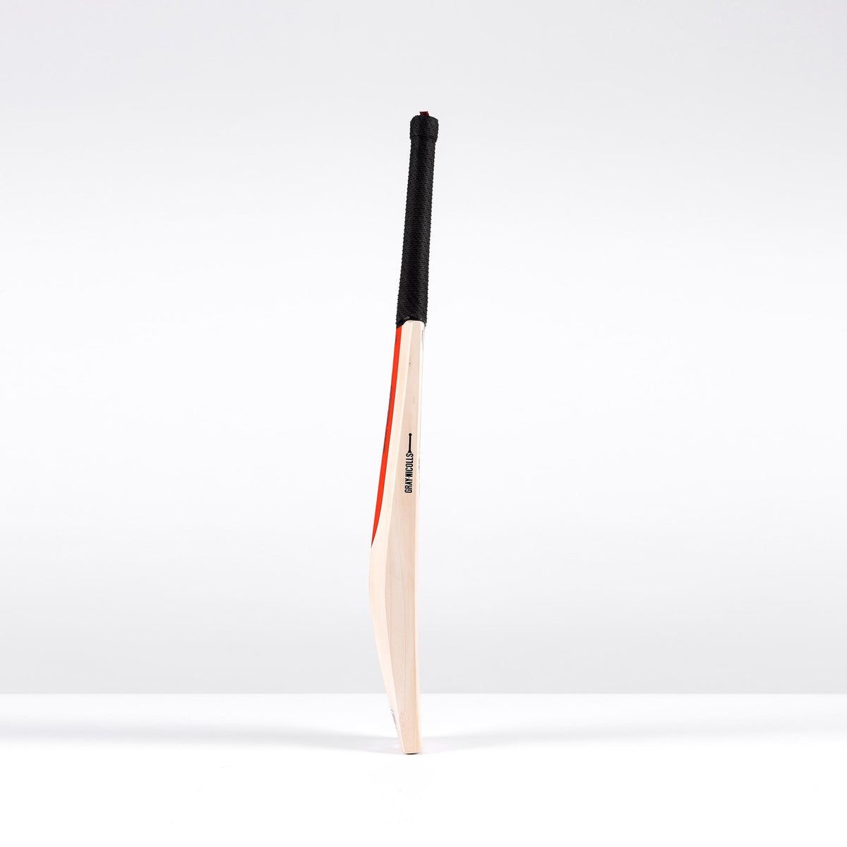 The Gray Nicolls Legend Platinum Edition SH Cricket Bat, a premium English willow bat with black handle and red accents, stands upright on a white surface, showcasing its expanded sweet spot against a plain white background.