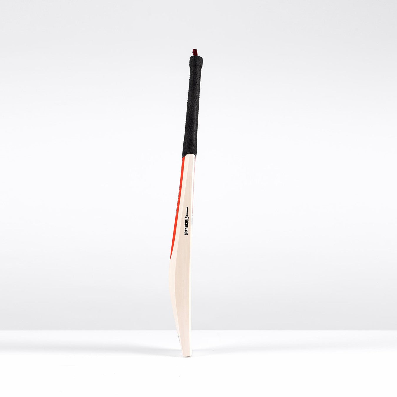 The Gray Nicolls Legend Silver Edition Junior Cricket Bat, featuring a black grip, expanded sweet spot, and red and black accents along the edge, stands upright against a plain white background.