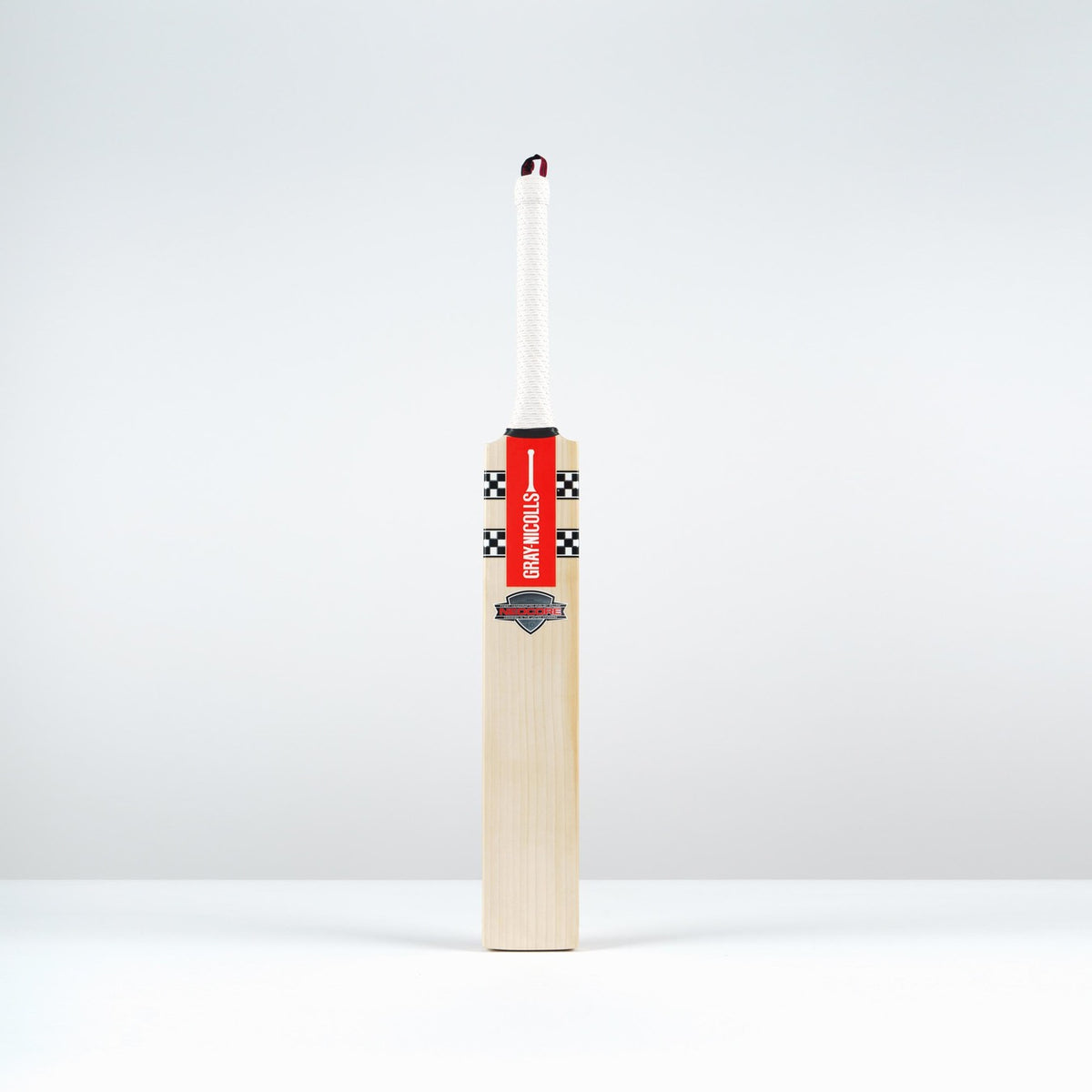 The Gray Nicolls Neocore Pro SH Cricket Bat 2026 stands upright with a large matchstick head attached to its handle, creatively blending Gray Nicolls sports equipment and a matchstick against a plain white background.