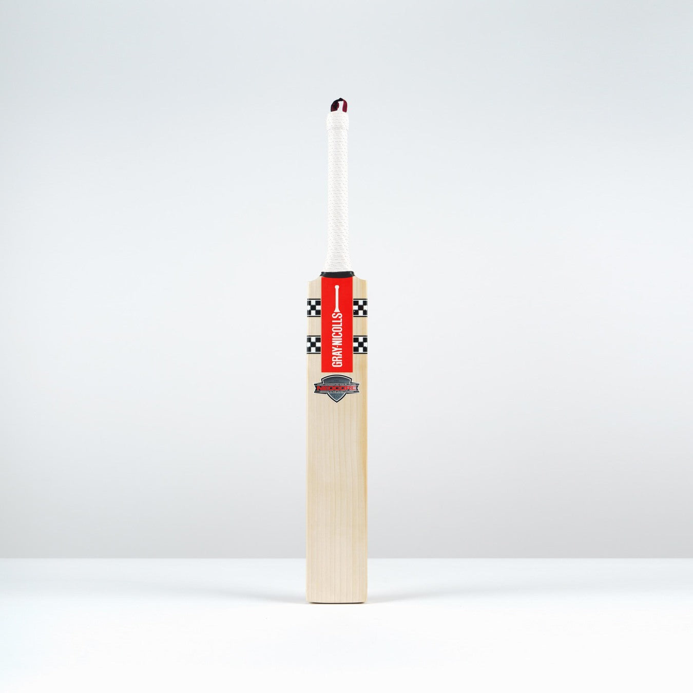 The Gray Nicolls Neocore Pro SH Cricket Bat 2026 stands upright with a large matchstick head attached to its handle, creatively blending Gray Nicolls sports equipment and a matchstick against a plain white background.
