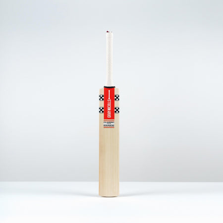 The Gray Nicolls Classic Pro Performance SH Cricket Bat 2026, featuring a mid blade profile and a red and black label, stands upright with a white candle in the top against a plain white background.