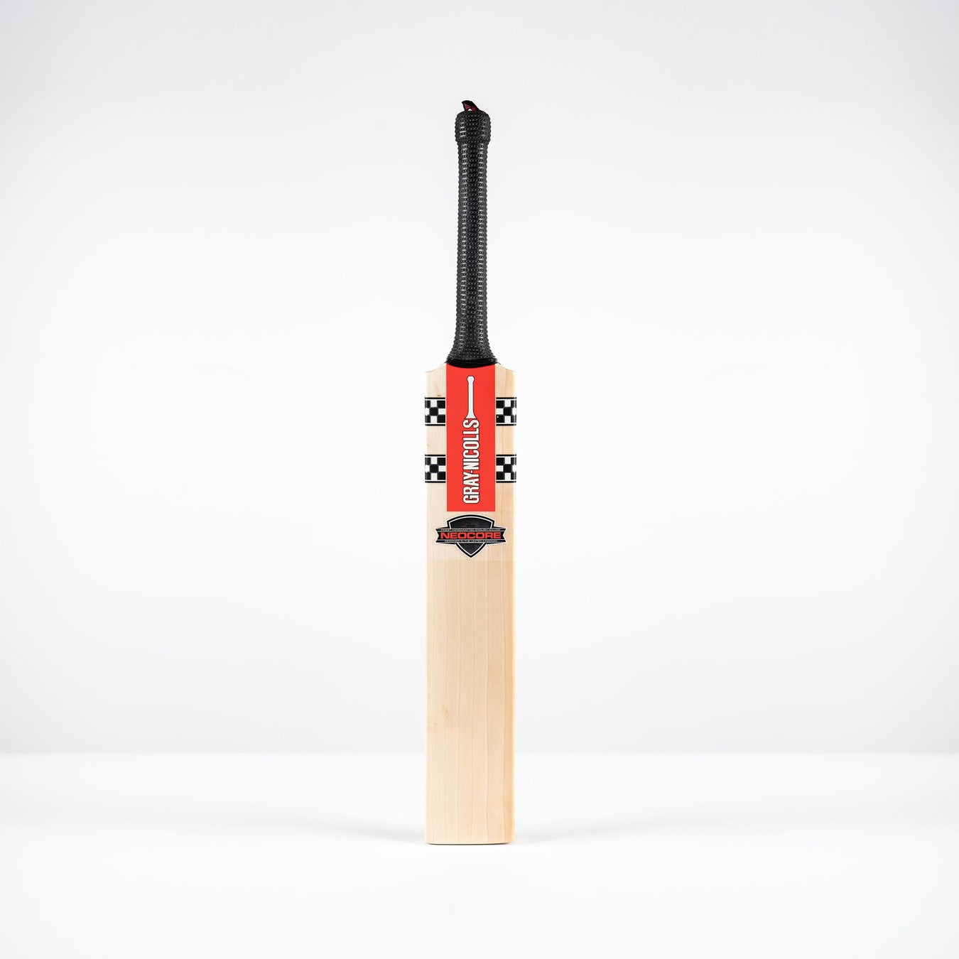 The Gray Nicolls Neocore 500 Harrow Cricket Bat 2026 stands upright on a white surface, featuring Pro Shape, NEOCORE technology, a black grip, and a red label against a plain white background.