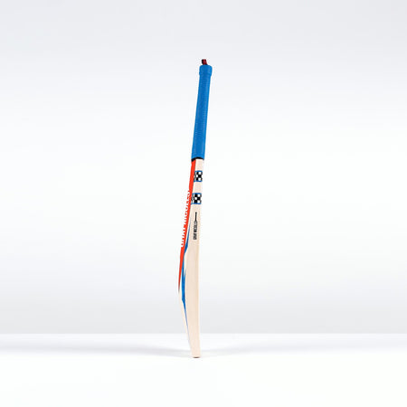 The Gray Nicolls Havoc 1.0 Neocore Players Edition SH 2026 bat stands upright with a blue grip and vibrant handle, offering explosive shot speed, and features the trusted quality of Gray Nicolls against a plain white background.